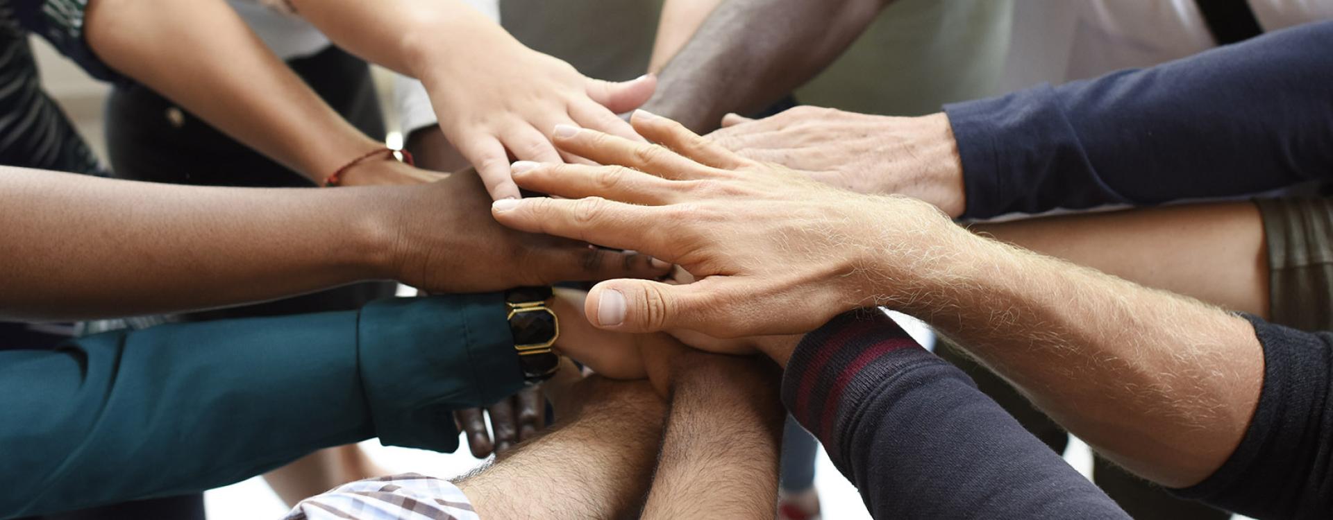 various hands coming together